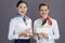 Portrait of happy elegant flight attendant women against grey