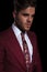 Portrait of a happy elegant young man in burgundy suit