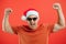 Portrait of happy and excited man in santa hat, rejoicing and winning something, celebrating new year, standing over red