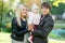 Portrait of happy family with daughter in autumn park