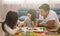 Portrait of happy family daughter girl is learning to use colorful play dough together with parent.