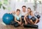 Portrait of happy family engaged in pilates sitting on the floor