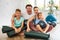 Portrait of happy family engaged in pilates sitting on the floor