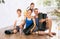 Portrait of happy family engaged in yoga sitting on the floor