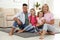 Portrait of happy family on floor at home