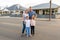 Portrait of Happy family of four embracing and smiling in front of new dream home