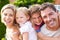 Portrait Of Happy Family In Garden