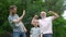 Portrait of happy family - grandpa, father and his son smiling and showing their muscles outdoor in park on background