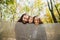 Portrait of happy family hiding behind a soft fabric fence in autumn park