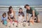 Portrait of happy family making sand castle at beach