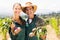 Portrait of happy farmer couple holding leafy vegetables