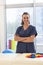 Portrait of happy female caucasian physiotherapist wearing scrubs at hospital