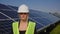 Portrait of happy female engineer in protective helmet crossing arms while looking to camera. Handsome woman in uniform