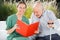 Portrait Of Happy Female Nurse Reading Book For