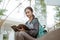 Portrait of happy female student reading holding book