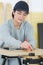 Portrait happy female woodworker drafting new project at workshop