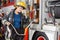 Portrait Of Happy Firefighter Adjusting Hose In