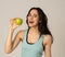 Portrait of happy fitness young latin woman with apple after workout training