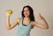 Portrait of happy fitness young latin woman with apple after workout training