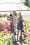 Portrait of happy gardeners standing outside greenhouse