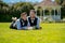 Portrait of happy gay couple laying on grass on wedding day. Gay couple wedding. Gay marriage. Homosexual couple