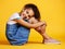 Portrait, happy and girl child on studio floor for children fashion, playful and sweet against yellow background. Face