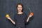 Portrait of happy girl holding fruits with drinking straws inserted