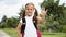 Portrait of happy girl with school bag standing outdoor. Little happy school girl going to school, back to school, education