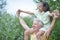 Portrait of happy grandfather and granddaughter having fun in park