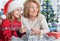 Portrait of happy grandmother with girl preparing for Christmas