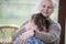 Portrait of happy grandmother hugging granddaughter in house