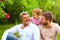 Portrait of happy grandpa, father and son in spring garden