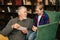 Portrait of happy grandpa talking with cute grandson, having fun looking at an old photo album.