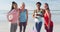 Portrait of happy group of diverse female friends having fun at the beach