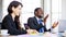 Portrait of a happy handsome African businessman clapping a hand in a multiracial meeting at the conference room with cute smiling