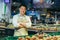 portrait of a happy handsome asian salesman. Vegetables and fruits at the market or grocery store. Seller. a man in an