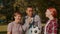 Portrait of happy hearing impaired family with soccer ball bonding outdoors