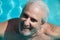 portrait of happy hoary man in swimming pool. summer holiday and vacation. happy retirement