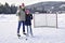 portrait of happy hockey girl player with his mother on a lake