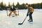 portrait of happy hockey player with his father on a lake