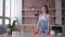 Portrait of happy housekeeper girl in rubber gloves during general cleaning of cuisine and household duties with