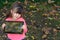 Portrait of happy kid holding tablet with both hands, showing it at camera while looking at screen with interested expression, sta