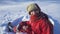 Portrait of happy kid sitting on the snow at winter park