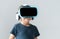 Portrait of happy kid in a virtual reality headset. Attractive kid using vr goggles over abstract background