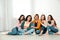 Portrait of happy ladies sitting on floor. Women power concept