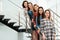 Portrait of happy ladies on stairs. Women power concept