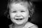 Portrait of a happy laughing baby. Close up positive kids face. Smiling infant, cute smile.