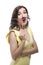 Portrait of Happy Laughing Caucasian Brunette Girl in Posing with Artificial Moustache in Yellow Dress Against White