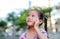 Portrait of happy little Asian child in garden with thinking and looking up. Close-up smiling kid girl with forefinger point on