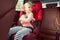 Portrait of happy little child girl sitting comfortable in car s